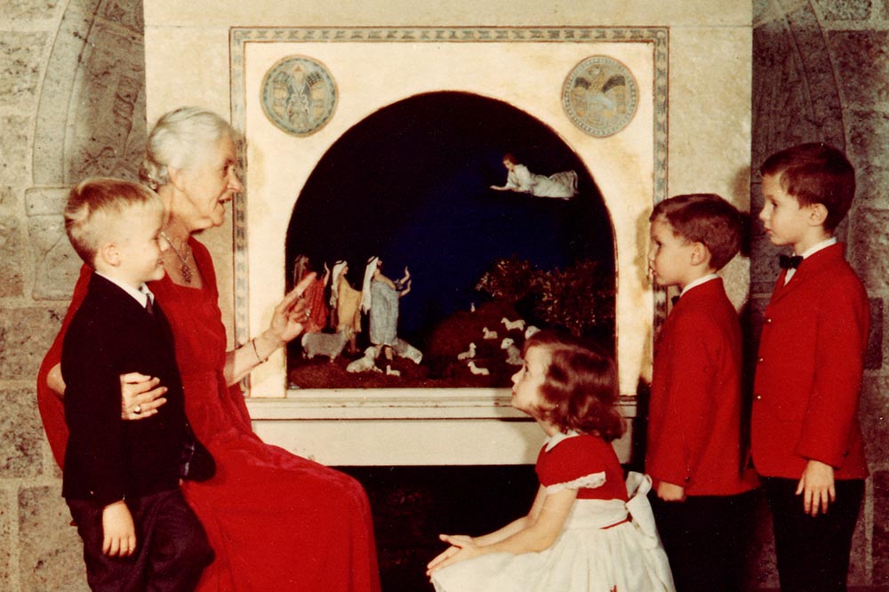 Woman explaining nativity scene to children